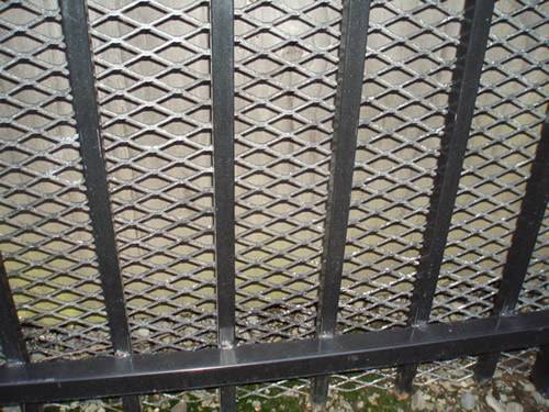 Green aluminum expanded metal meshes with diamond holes are installed on the architectural building facades by trellis.