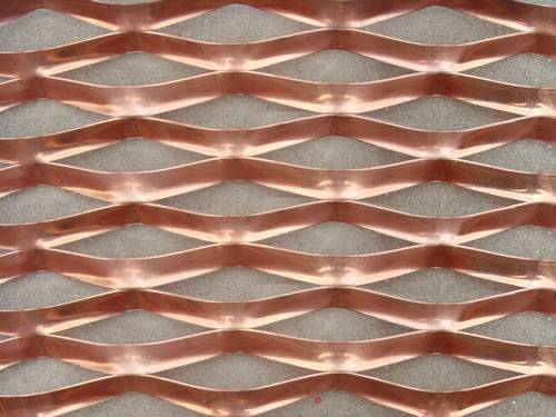 Golden aluminum expanded metal meshes with diamond holes are installed on interior wall.