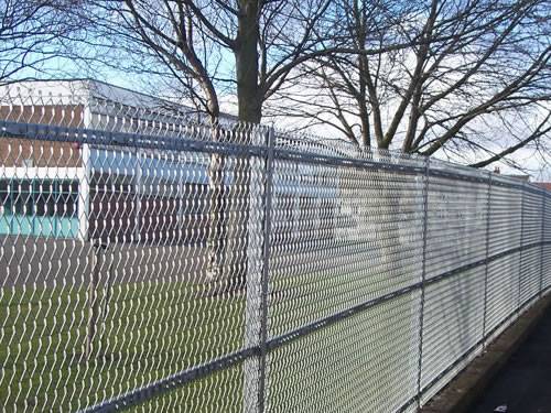 Green aluminum expanded metal meshes with diamond holes are installed on the architectural building facades by trellis.