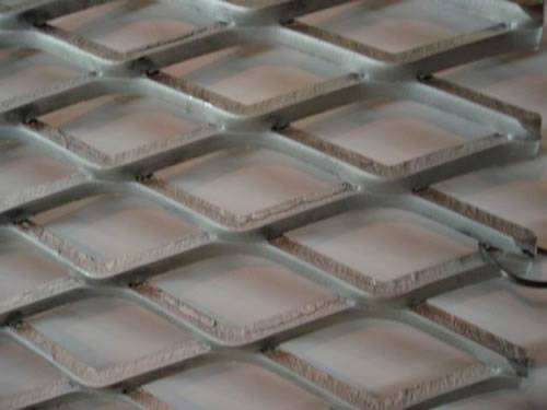 Green aluminum expanded metal meshes with diamond holes are installed on the architectural building facades by trellis.