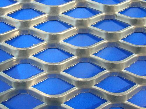 Green aluminum expanded metal meshes with diamond holes are installed on the architectural building facades by trellis.