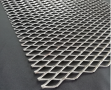 Golden aluminum expanded metal meshes with diamond holes are installed on interior wall.