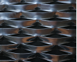 Golden aluminum expanded metal meshes with diamond holes are installed on interior wall.