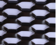 Golden aluminum expanded metal meshes with diamond holes are installed on interior wall.